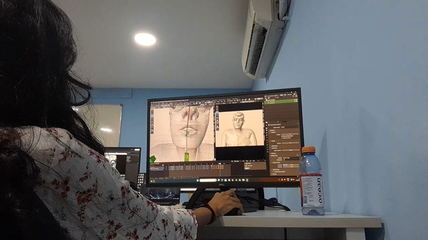 a girl working on a 3D character model in a software interface on a desktop monitor.