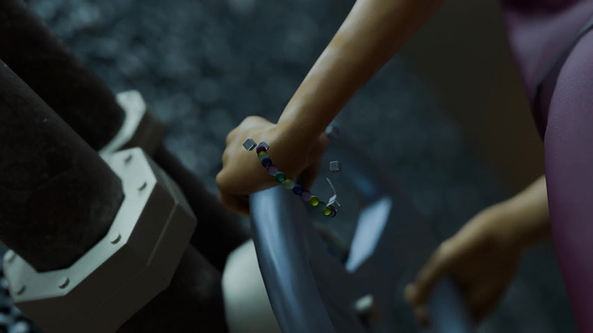 Close-up of a person's hands turning a large industrial valve wheel.