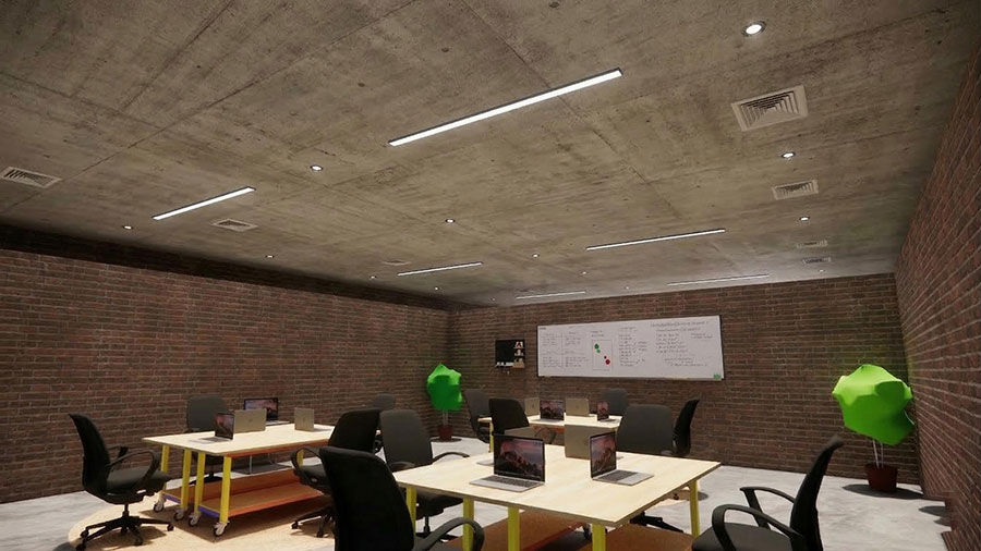 An industrial-style co-working space or classroom with exposed concrete ceilings and red brick walls.