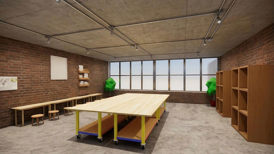 An industrial-style workshop or studio space featuring exposed concrete ceilings with metal conduit lighting and red brick walls.