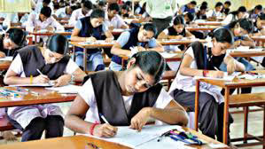 Students writing intently during an examination.